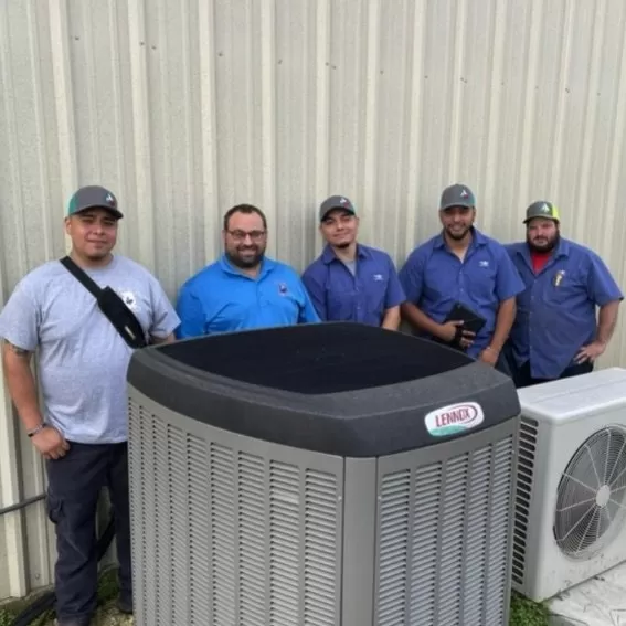 Five Texas Ace Heating & Air technicians posing for a team picture with two HVAC systems Lennox and LG.
