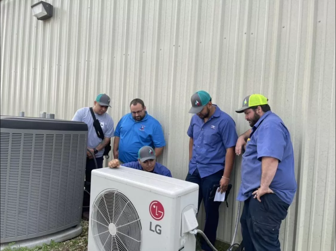 Texas Aces HVAC team inspecting and air conditioning unit in Dallas TX