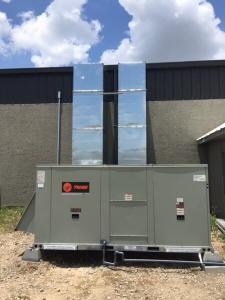 HVAC unit installed on the ground outside of a building in Dallas, Tx.