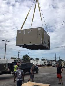 HVAC unit being lifted into the air near Dallas, TX.