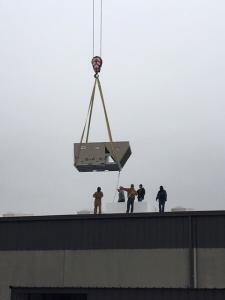 HVAC unit being lowered onto a roof in Dallas, Tx.