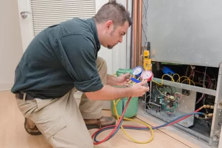 A Fort Worth HVAC contractor working on the HVAC electrical system